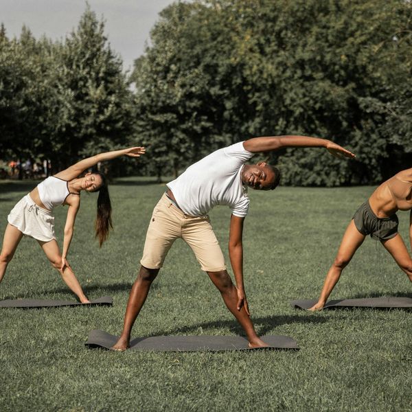 Diverse group of people smiling, suggesting the practice is suitable for everyone.