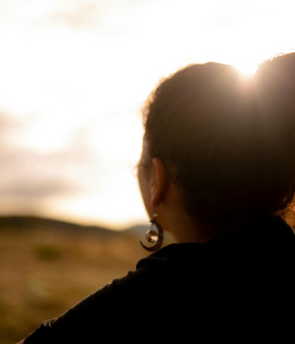 Woman in a peaceful yoga pose, finding evening calm for her neck and shoulders.